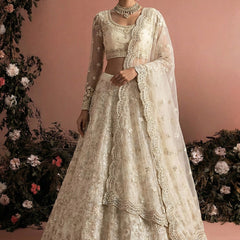 Off White Net Heavy Embroidered Wedding Lehenga