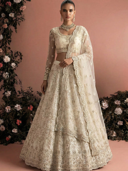 Off White Net Heavy Embroidered Wedding Lehenga
