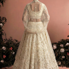 Off White Net Heavy Embroidered Wedding Lehenga