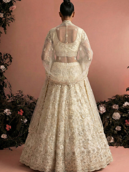 Off White Net Heavy Embroidered Wedding Lehenga
