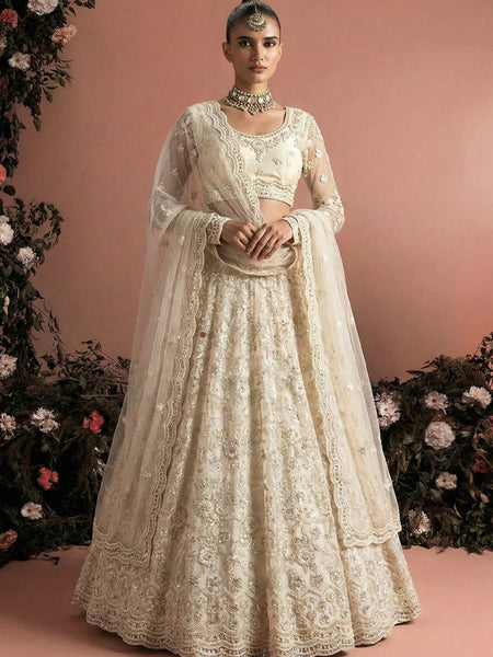 Off White Net Heavy Embroidered Wedding Lehenga