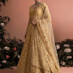 Beige Net Heavy Embroidered Wedding Lehenga